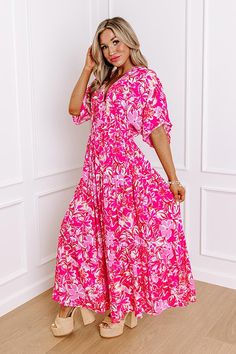 - Your style will blossom like a wildflower with this breezy dress! - Lightweight material with a pink hued floral print - A built-in partial skirt lining ending thigh length - A v-cut neckline with two hidden hook and eyes for additional coverage - Loose short sleeves - A cinched waistline with an elastic back - A flowy yet flattering silhouette that ends in a straight maxi length hemline Measurements S : Bust 34", Hip 36", Length 52", Sleeve Length 16", Waist 26-30". M : Bust 36", Hip 38", Len Pink Floral Print V-neck Maxi Dress, Pink Floral V-neck Dress For Brunch, Pink Tropical Print V-neck Maxi Dress, Pink V-neck Maxi Dress With Tropical Print, Pink Tropical Print Maxi Dress, Summer Floral Print Pink Maxi Dress, Summer Pink Printed Maxi Dress, Pink Floral Print Maxi Dress For Summer, Pink Floral Printed Dress For Spring