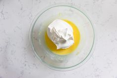 a glass bowl filled with whipped cream and orange juice