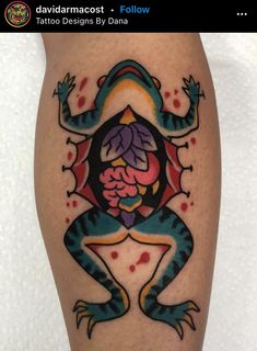 a colorful tattoo design on the leg of a person's leg, with an image of a frog holding a flower