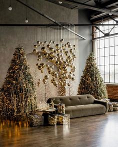 a living room filled with lots of christmas trees next to a couch and coffee table