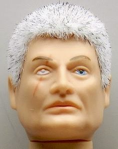 the head of a male mannequin with silver hair and blue eyes is shown