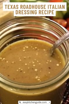 a jar filled with dressing sitting on top of a table next to other food items