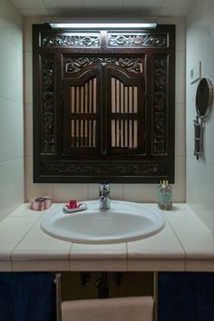 a bathroom sink under a mirror next to a window