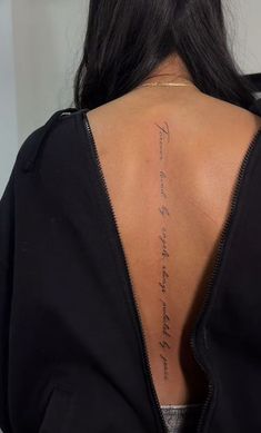 the back of a woman's neck with writing on it and an inscription that reads,