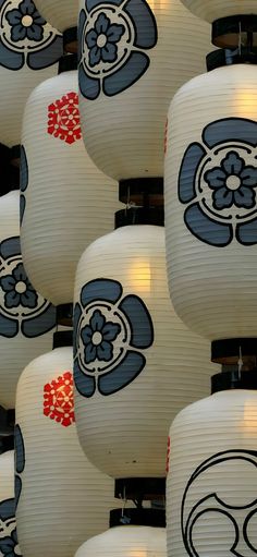 many white lanterns with blue and red designs on them