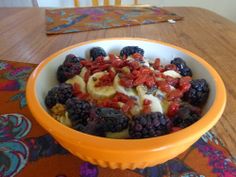 a bowl filled with fruit on top of a wooden table