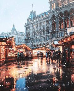 people are walking around in the rain with umbrellas and christmas decorations on display at an outdoor market