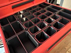 an open red toolbox filled with lots of trays