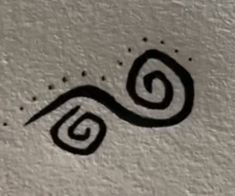 an image of a black and white drawing on the side of a building with water drops coming out of it