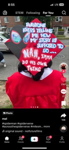 a person wearing a red graduation cap with stickers on it