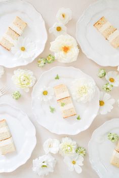 slices of cake on white plates surrounded by flowers