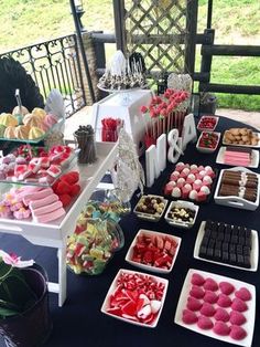 a table topped with lots of different types of desserts