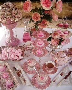 a table topped with lots of pink desserts