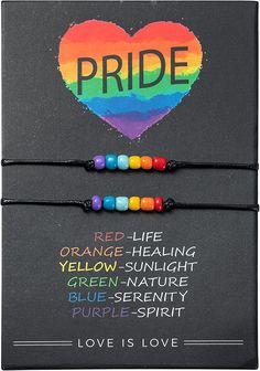 two bracelets with the words pride written on them and a rainbow heart in the background