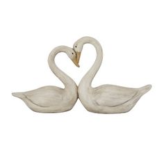 two white swans making a heart shape with their necks