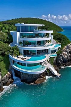 an aerial view of a modern house on the water with a boat floating in it