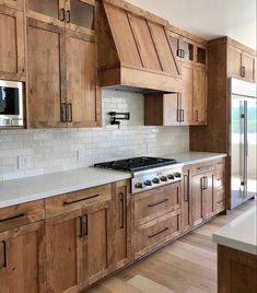 a large kitchen with wooden cabinets and white counter tops is featured on the instagram page