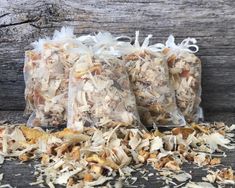 three bags filled with different types of food on top of a wooden table next to a bag