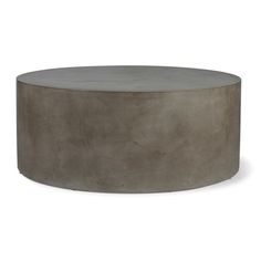 the concrete coffee table is round and grey