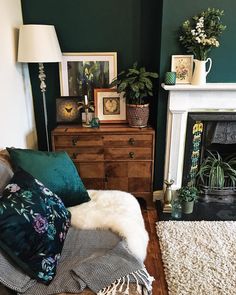 a living room filled with furniture and a fire place next to a white rug on top of a hard wood floor