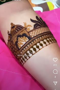 a woman's arm with henna tattoos on it