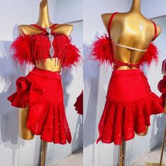 two mannequins dressed in red clothing with feathers