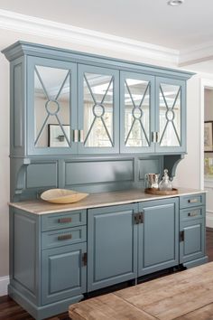 a kitchen with blue cabinets and wooden floors