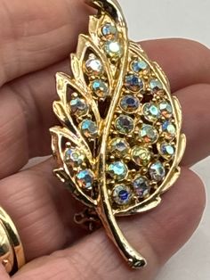 Vintage Aurora Borealis crystal gold tone brooch with roll over clasp Gold Jeweled Costume Jewelry Brooch, Gold Clip-on Costume Jewelry Brooch, Jewelry Board, Aurora Borealis Crystal, Jewelry Boards, Jewelry Lover, Aurora Borealis, Vintage Brooches, Costume Jewelry