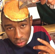 a man with a pancake on his head and a knife sticking out of it