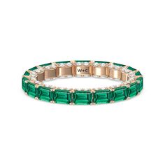 This eternity ring showcases a stunning balance between vintage glamour and feminine romance. It features emerald-cut created Emerald in an east-west setting evoking Art Deco's architectural splendor. Each emerald-cut diamond is set on a thick U-shaped prong punctuated by a pair of petite round diamonds on its side. The curved yellow gold prongs form a circle and makeup the graceful, scalloped base of the band. Luxury Emerald Ring With Rectangular Stone For Wedding, Luxury Emerald Ring With Rectangular Stone, Luxury Rectangular Emerald Wedding Ring, Luxury Stackable Emerald Cut Emerald Ring, Luxury Stackable Emerald-cut Emerald Ring, Gorgeous Engagement Ring, Emerald Gemstone, Emerald Cut Diamonds, Vintage Glamour