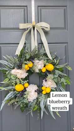 a lemon and blueberry wreath hanging on the front door