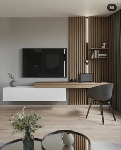 a living room with a large television on the wall next to a table and chairs