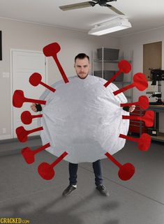 a man holding a large white object with red circles around it