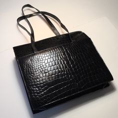 Sleek Black Alligator Embossed Leather Tote. Two Side Vent Pockets, Top Zipper Closure Opens To An Interior Of Black Leather With A Zippered Pocket. Over-The-Shoulder Straps. Excellent Bag For Office Or Everyday! New Without Tags (Nwot), Never Used! Width 14 Inches, Height 13 Inches, Depth 4 Inches At Bottom. Strap Drop Is 17 Inches. Pet / Smoke Free Environment. Thank You For Shopping New And Like New! Black Crocodile Pattern Shoulder Bag For Work, Black Crocodile Pattern Bag For Work, Black Alligator, Black Leather Tote, Womens Tote Bags, Embossed Leather, Leather Tote, Alligator, Shoulder Straps