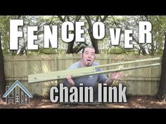 a man holding a wooden plank over his head with the words fence over chain link