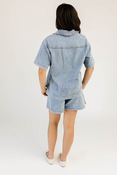 the solution to your summer // fall outfit woes, this button-up denim top + short set is an iconic essential. featuring an oversized short sleeve top + coordinating wide-leg denim shorts, it’s a set you can style together or separately for endless outfit possibilities. we love it paired with cowboy boots, chunky loafers, + everything in between denim blue // collared, breast pockets, buttons, high waisted, one button fly zip, belt loops, front + back pockets, wide leg model is 5'8" + wearing a s Relaxed Fit Short Sleeve Denim Jumpsuit, Short Sleeve Relaxed Fit Denim Jumpsuit, Trendy Collared Denim Jumpsuit For Summer, Trendy Relaxed Fit Denim Jumpsuit With Short Sleeves, Trendy Short Sleeve Denim Jumpsuit In Relaxed Fit, Trendy Short Sleeve Denim Jumpsuit With Relaxed Fit, Trendy Short Sleeve Relaxed Denim Jumpsuit, Summer Casual Collared Denim Jumpsuit, Casual Collared Denim Jumpsuit For Summer