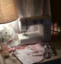 a sewing machine sitting on top of a table next to a lamp