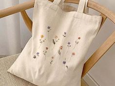 "Aesthetic Wild Flowers Canvas Tote Bag, Vintage Flowers Cute Canvas Tote Bag, Gardening Aesthetic Tote Bag, Botanical Flowers Canvas Tote   This 100% cotton bag comes in one size - 15\" x 16\"- perfect for everyday wear. The bag features 20\" handles (made from the same canvas), making it easy to carry even with a week's worth of shopping. - Liberty Bags OAD113 - ⭐ PRODUCT DETAILS ⭐ 💖 100% cotton canvas. 💖 Heavy fabric (12 oz/yd² (406.9 g/m 💖 Sewn-in label ⭐ CARE INSTRUCTIONS ⭐ 💖Machine wash: cold (max 30C or 90F) 💖Non-chlorine: bleach as needed 💖Tumble dry: medium heat 💖Do not iron directly over the printed area - print may stick to the iron. 😊If you have any questions please feel free to ask me😊" Beige Flower-shaped Canvas Bag For Daily Use, White Botanical Rectangular Bag, Botanical Rectangular Canvas Bag For Daily Use, Botanical Style Canvas Bag For Daily Use, Botanical Style Rectangular Canvas Bag For Daily Use, White Botanical Style Bag For Spring, Botanical Bags For Everyday Use In Summer, Spring Botanical Rectangular Bags, Gardening Aesthetic