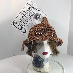 a white mannequin head wearing a brown hat