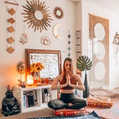 a woman is sitting on the floor in her living room doing yoga exercises for herself