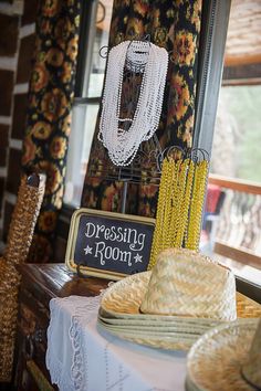 there is a table with hats on it and a sign that says dress up room