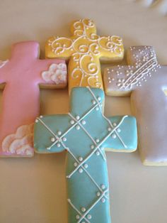 decorated cookies in the shape of crosses on a table