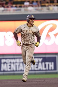 a baseball player is running on the field