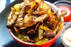 a red bowl filled with fried potato chips