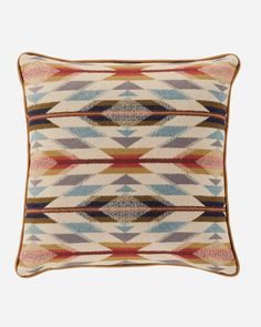 a multicolored pillow with an intricate design on the front and back, made from wool