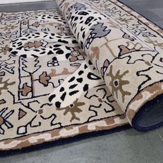 a rug is laying on the floor with it's end rolled up to show an animal print pattern