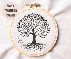 a cross stitch tree with the words simply transferer & create it on it's hoop