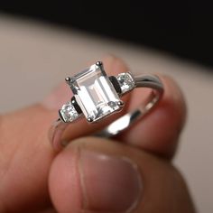 This is a gorgeous handmade creation. Its beauty is its simplicity & Elegance. The 6*8 mm emerald shape faceted natural white topaz is crafted in solid sterling silver and with rhodium plated. All item is sent in a beautiful gift box If you have any idea of design your ring,pls contact me directly. You can realize more lovely stuff clicking the link https://www.etsy.com/shop/knightjewelry?refshopsection_shophome_leftnav Please leave the correct address and you phone number for delivering suc Modern Sterling Silver Emerald-cut Diamond Ring, Emerald Cut White Topaz Promise Ring, Emerald Cut White Topaz Diamond Ring For Promise, Silver Octagon Topaz Promise Ring, Minimalist Silver Emerald Cut Diamond Ring, Classic Emerald-cut Topaz Ring In Sterling Silver, White Emerald Cut Cubic Zirconia Ring, White Emerald Cut Emerald Ring, Classic Emerald Cut Birthstone Ring In Sterling Silver