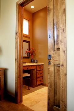 an open door leading to a bathroom with a sink