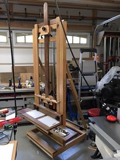 an artisan's easel is being worked on in a workshop with other tools